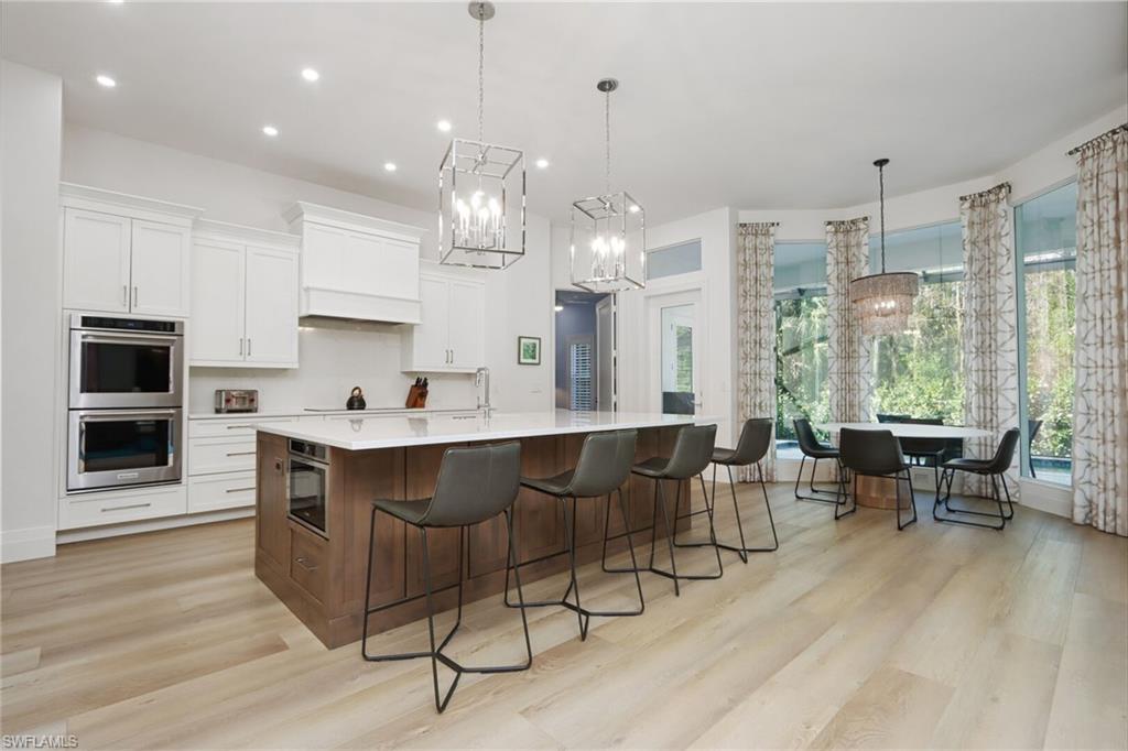 6665 Mill Run Road Naples, FL 34109 - Photo 6 of 30 a view of a dining room with furniture window and wooden floor