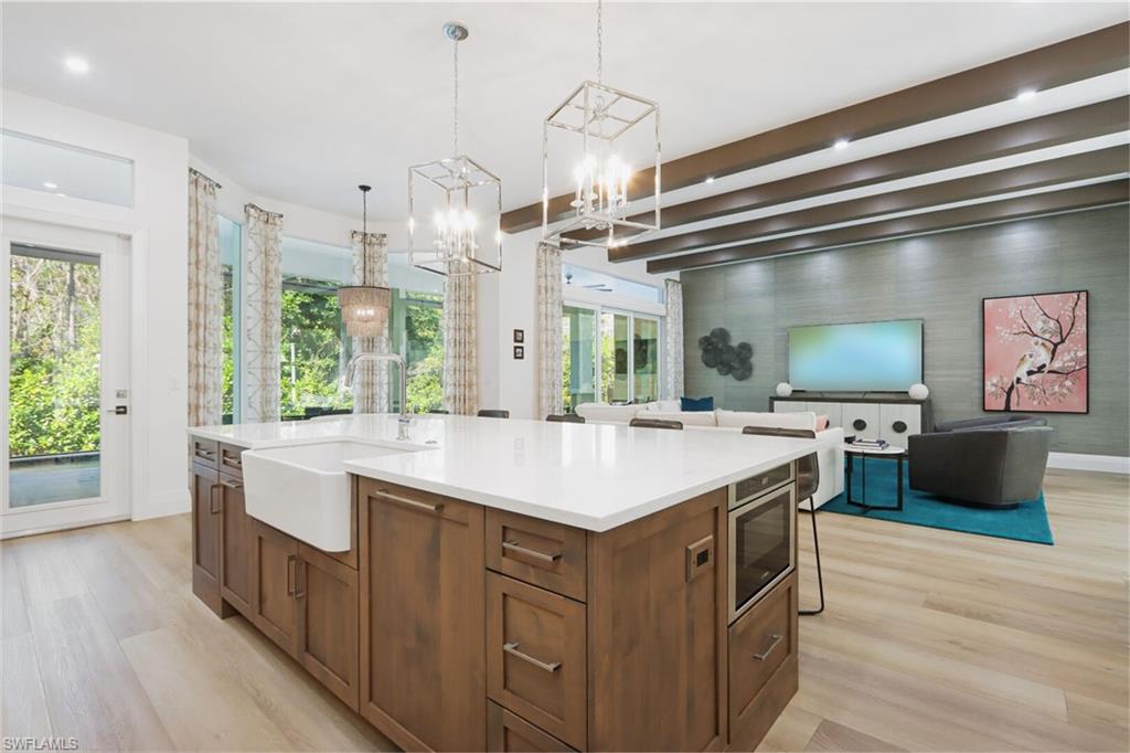 6665 Mill Run Road Naples, FL 34109 - Photo 30 of 30 a kitchen with a sink and wooden floor