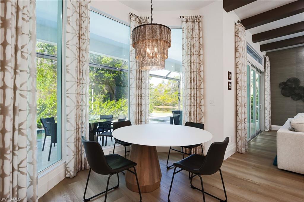 6665 Mill Run Road Naples, FL 34109 - Photo 8 of 30 a view of a dining room with furniture window and outside view