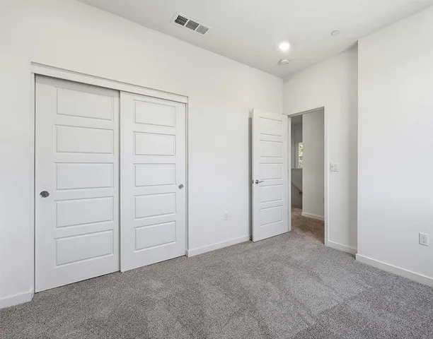 an empty room with closet area