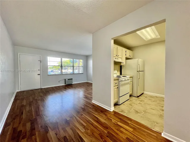 a view of a kitchen cabinets and wooden floor