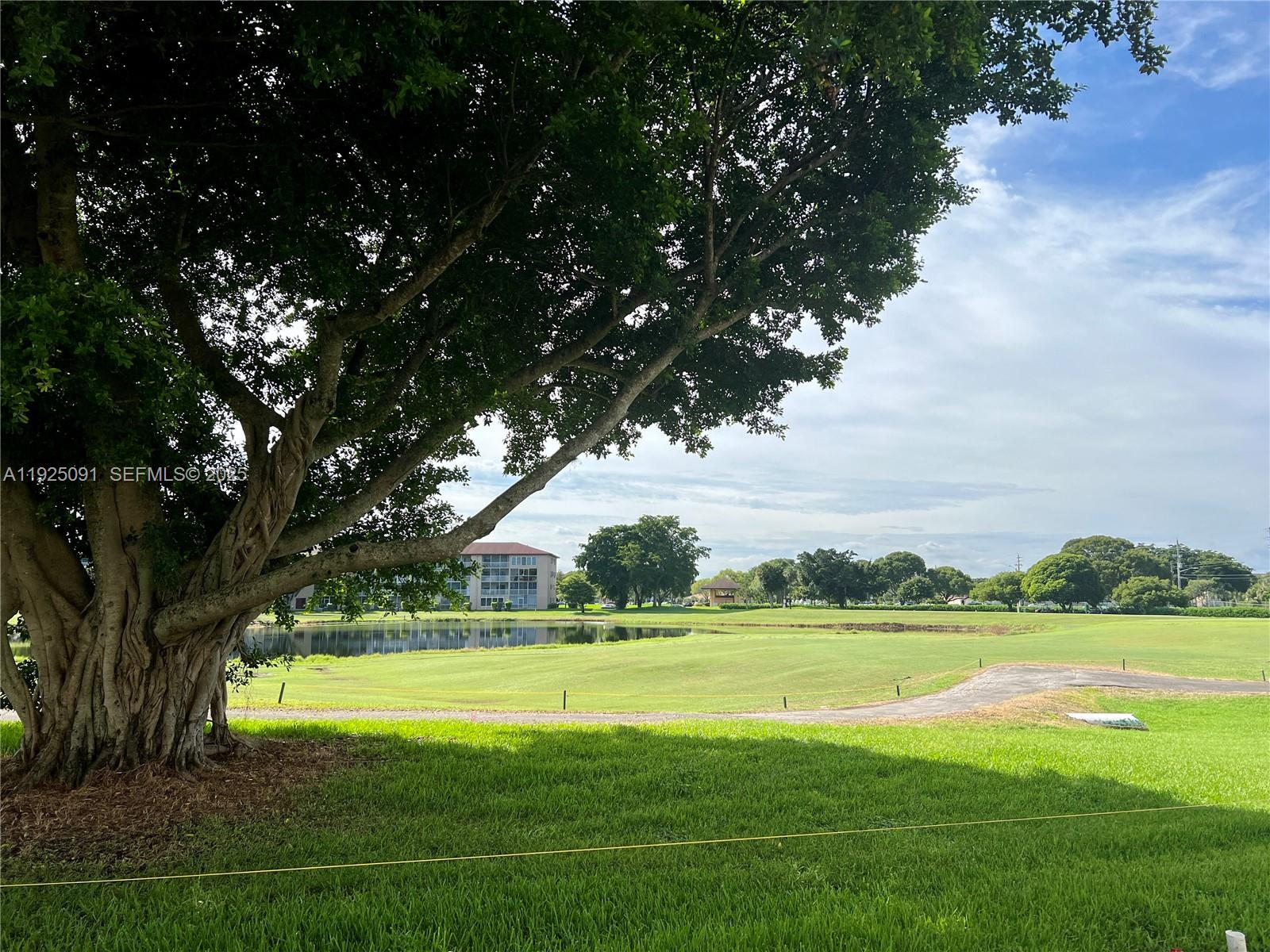 13550 Southwest 6th Court, Unit 109A Pembroke Pines, FL 33027 - Photo 9 of 11 a view of building with swimming pool and green space