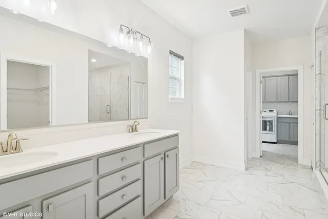 a spacious bathroom with a sink and a mirror