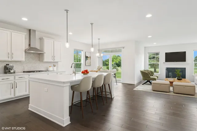 a kitchen with a table chairs stove and kitchen island