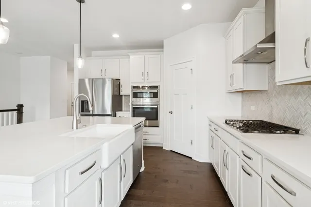 a kitchen with stainless steel appliances a sink stove and refrigerator