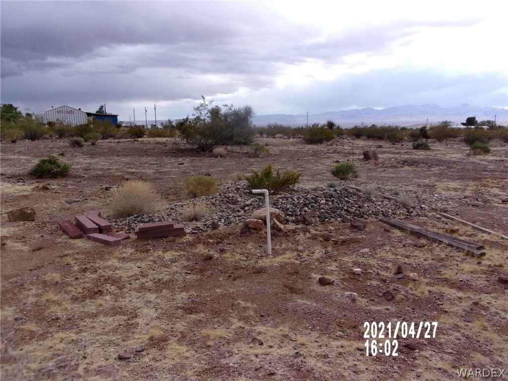 321 South Tooman Road Golden Valley, AZ 86413 - Photo 11 of 16 a view of a dry yard with wooden fence
