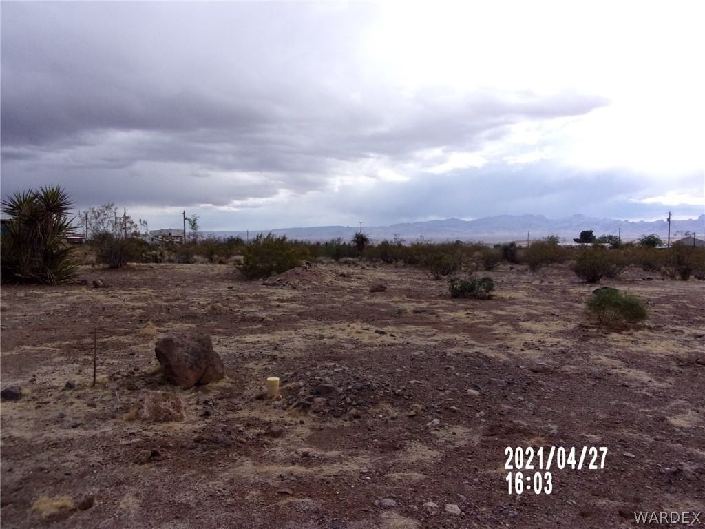 321 South Tooman Road Golden Valley, AZ 86413 - Photo 14 of 16 a view of a dry yard with wooden fence