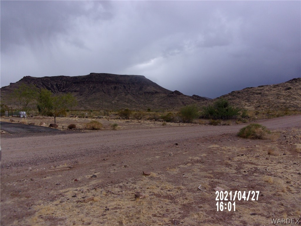 321 South Tooman Road Golden Valley, AZ 86413 - Photo 9 of 16 a view of a dry yard with mountains in the background