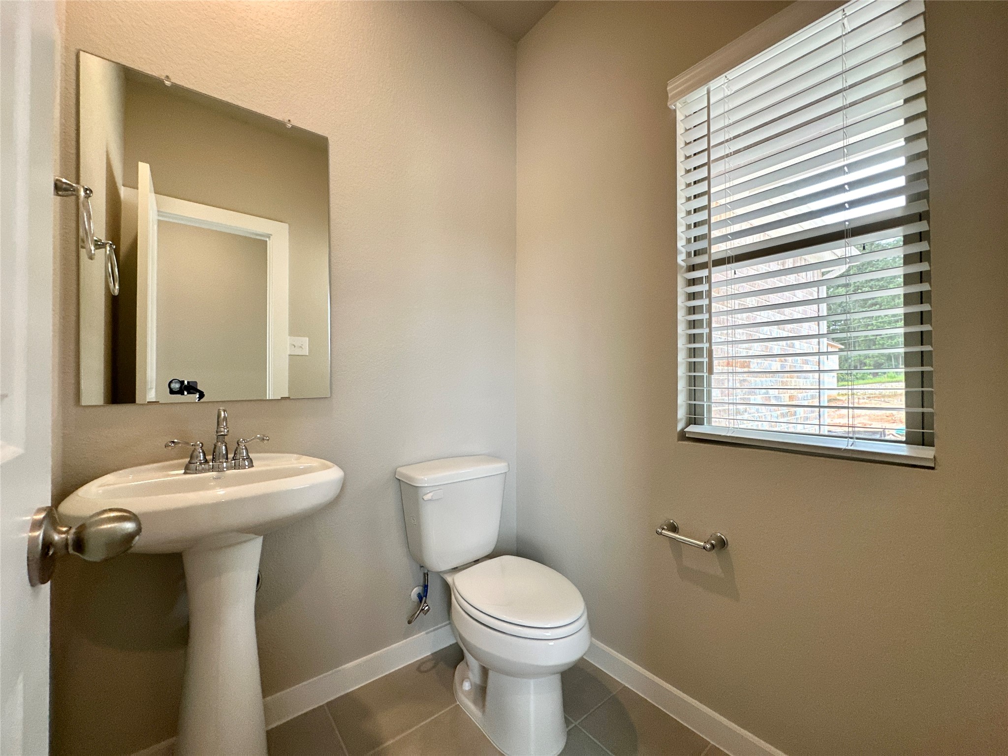 12198 Ridge Top Drive Conroe, TX 77304 - Photo 9 of 27 a bathroom with a toilet sink and mirror