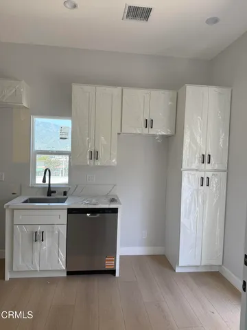 a view of kitchen with stainless steel appliances granite countertop a sink and a stove
