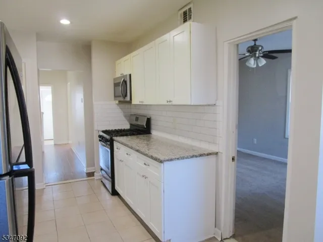 a kitchen with a sink and a refrigerator