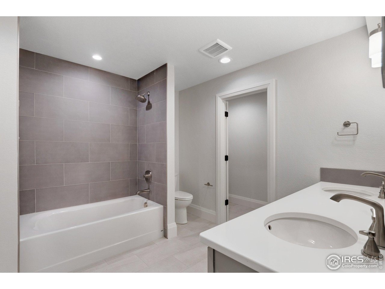 5700 2nd Road Greeley, CO 80634 - Photo 30 of 40 The upstairs full guest bath, which also features full-height tile