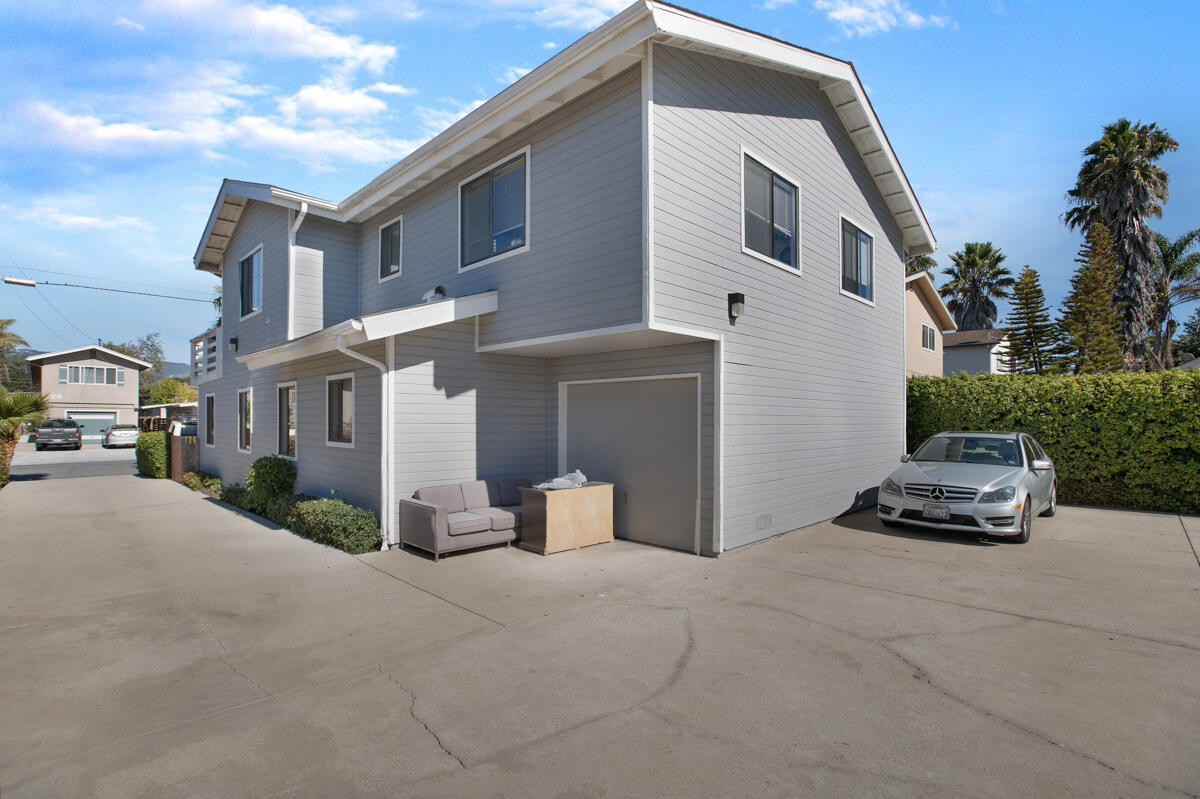 6709 Trigo Road Goleta, CA 93117 - Photo 5 of 13 a car parked in front of a white house