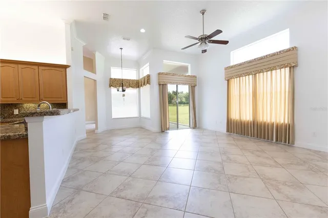 a view of a kitchen with furniture and a ceiling fan