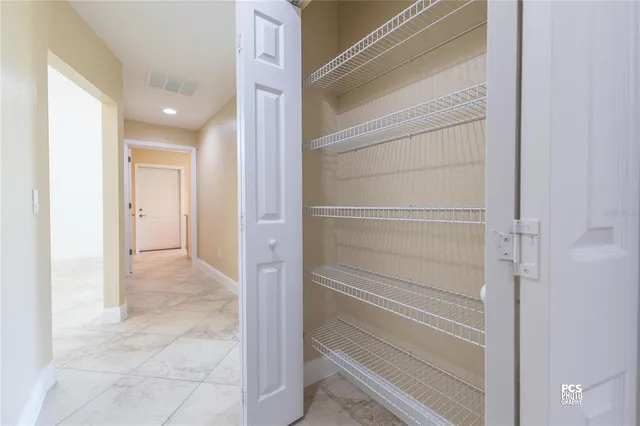 a view of closet area with empty racks
