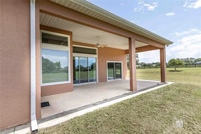 a view of porch with a floor to ceiling window next to a yard