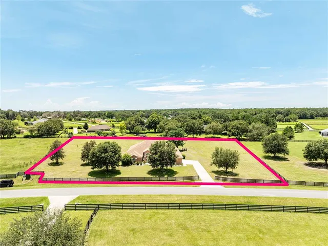 a view of swimming pool and red chair