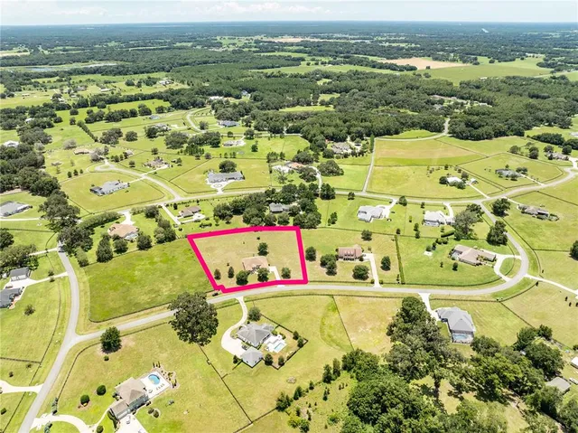 an aerial view of residential houses with outdoor space and city view