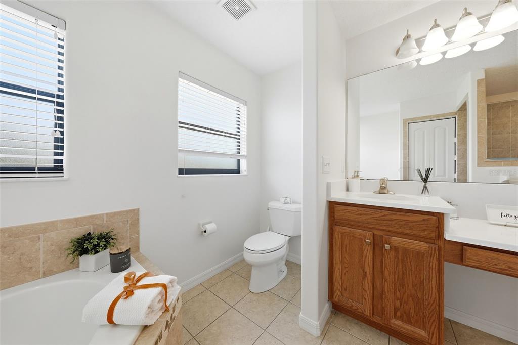 14433 Lake Yale Road Umatilla, FL 32784 - Photo 14 of 38 a bathroom with a sink vanity mirror and toilet