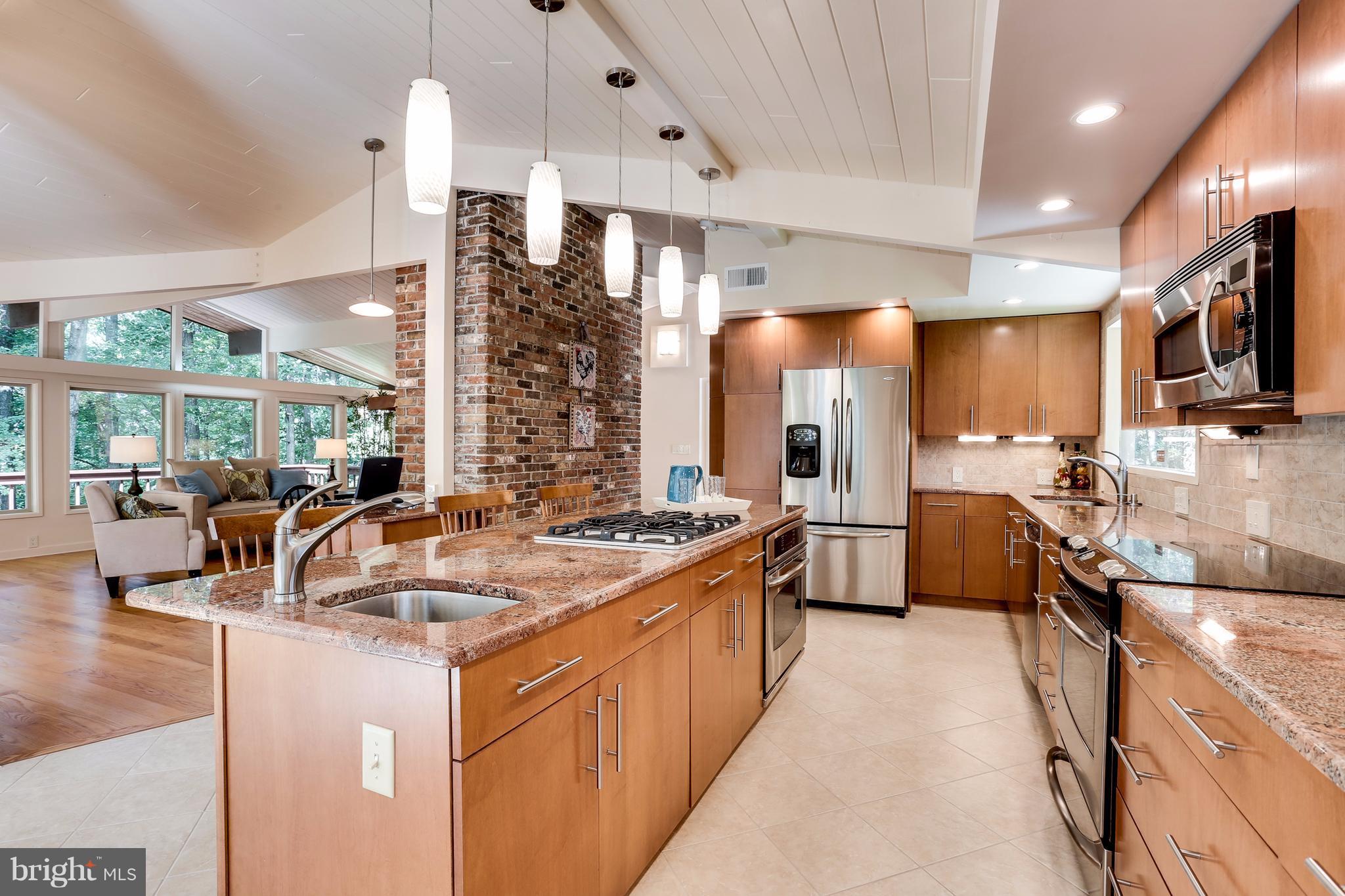 a kitchen with stainless steel appliances a sink stove and refrigerator