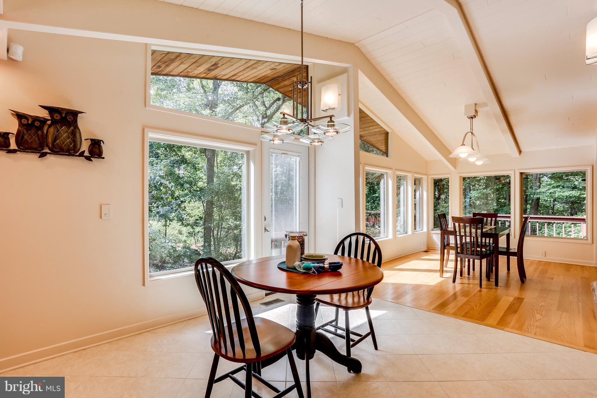 10900 Moxley Road Damascus, MD 20872 - Photo 14 of 30 a dining room with furniture a chandelier and wooden floor