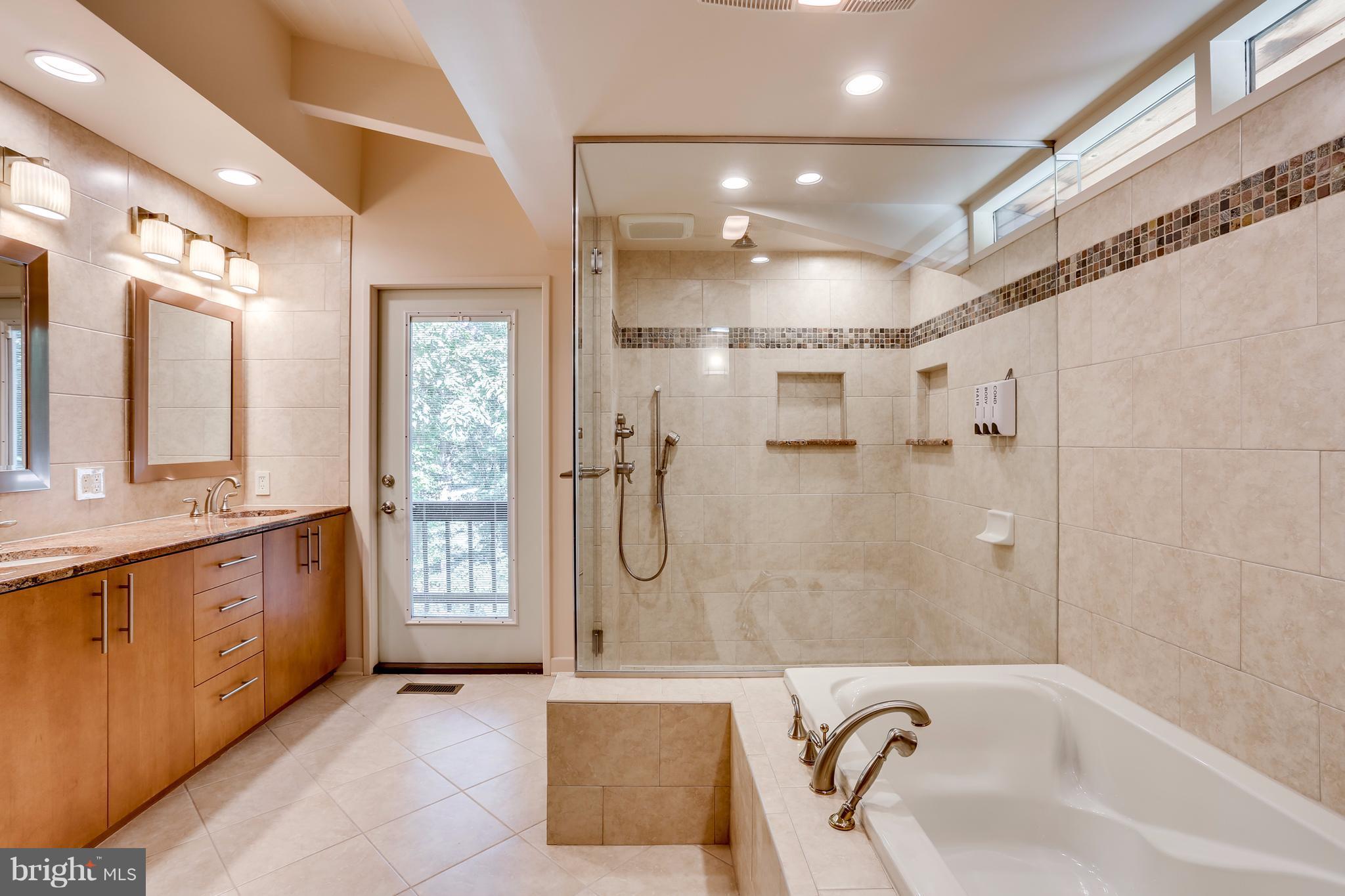 10900 Moxley Road Damascus, MD 20872 - Photo 17 of 30 a bathroom with a bathtub shower and sink
