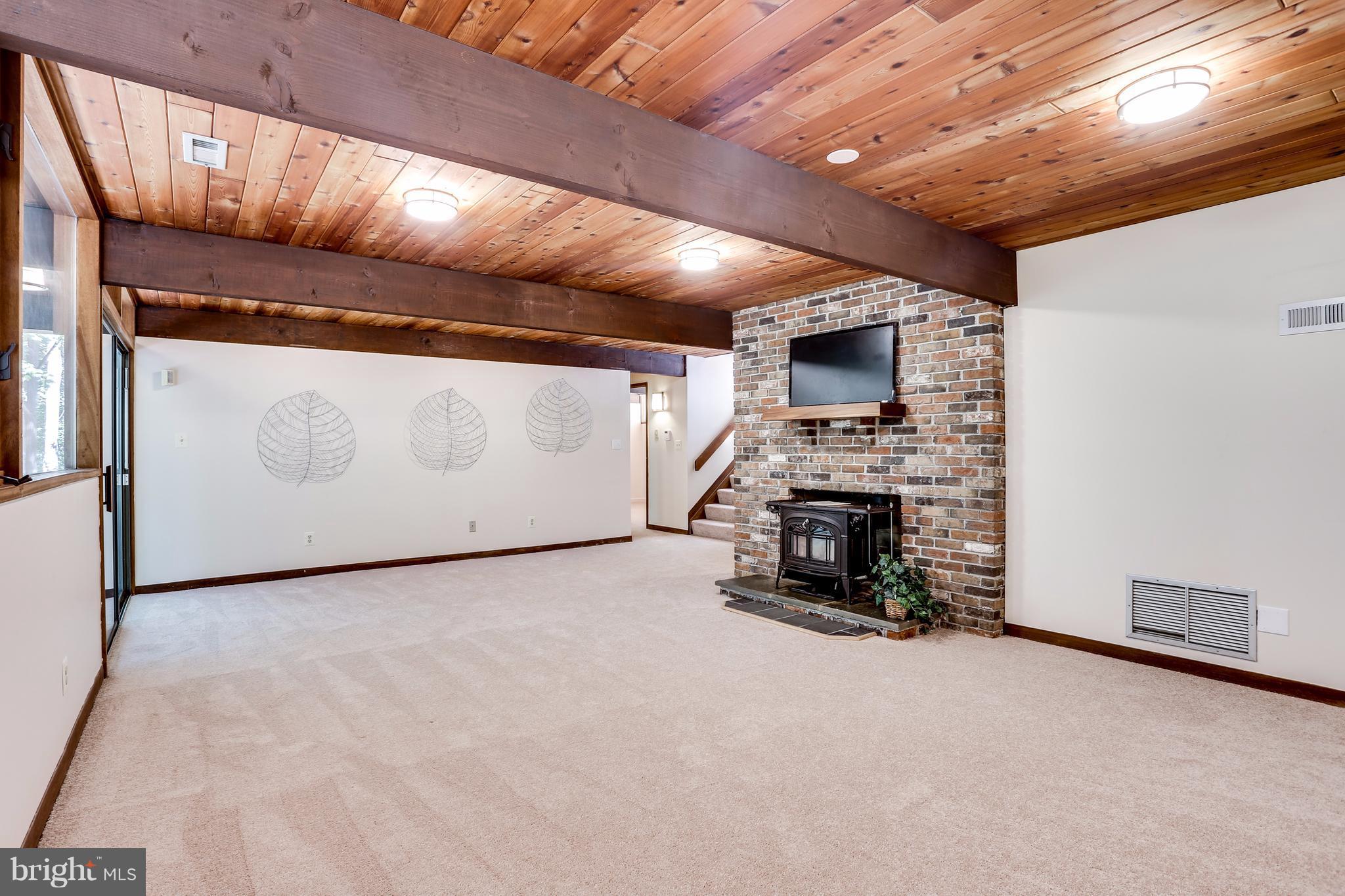 10900 Moxley Road Damascus, MD 20872 - Photo 19 of 30 a view of an empty room with fireplace and a window