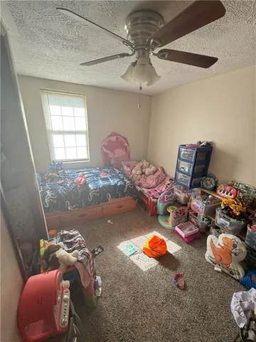 a gym room with furniture and a chandelier