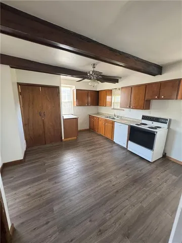 a view of kitchen with sink microwave and stove