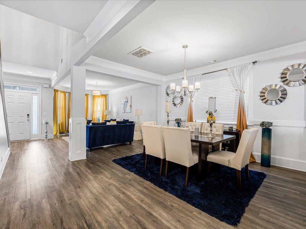 7675 Volion Drive Fairburn, GA 30213 - Photo 19 of 44 a living room with furniture or wooden floor and a chandelier