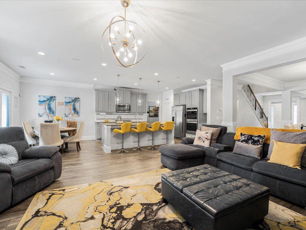 7675 Volion Drive Fairburn, GA 30213 - Photo 24 of 44 a living room with furniture kitchen view and a chandelier