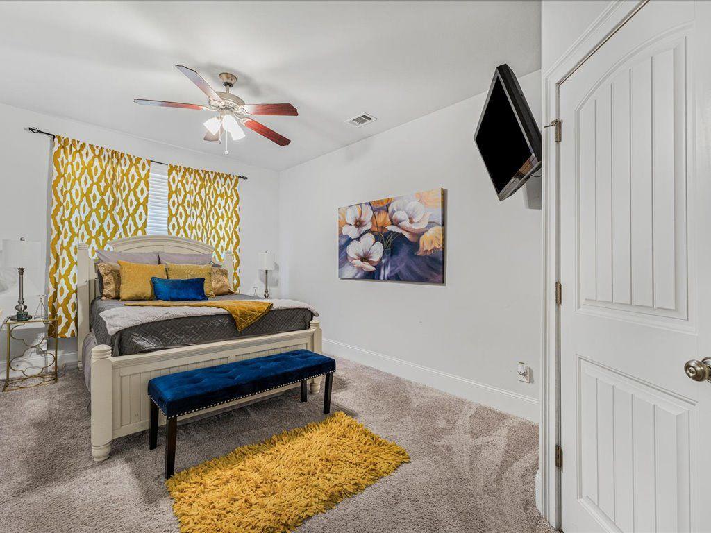7675 Volion Drive Fairburn, GA 30213 - Photo 28 of 44 a living room with furniture and a flat screen tv