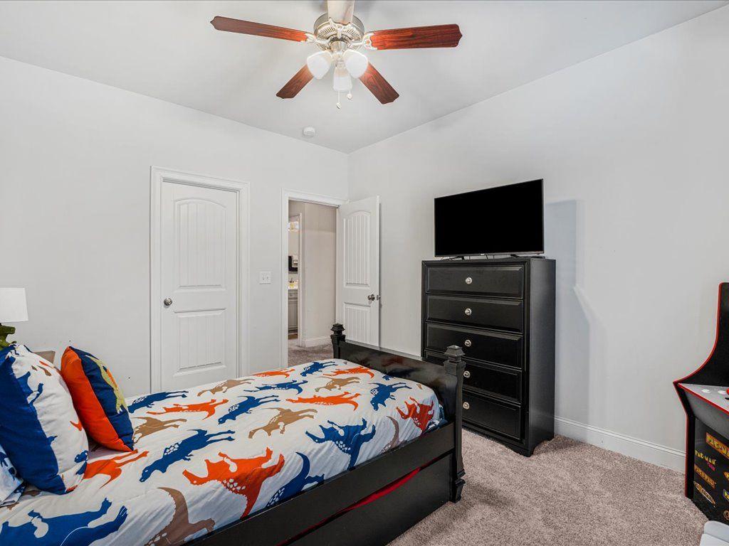 7675 Volion Drive Fairburn, GA 30213 - Photo 32 of 44 a bedroom with a bed and a flat screen tv