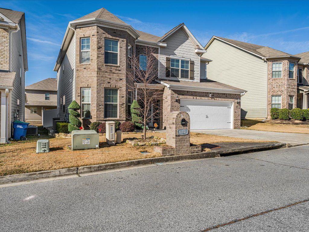 7675 Volion Drive Fairburn, GA 30213 - Photo 43 of 44 a front view of a house with a yard