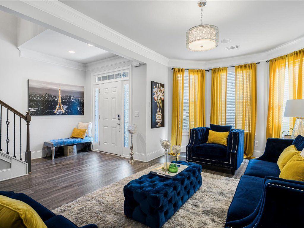 7675 Volion Drive Fairburn, GA 30213 - Photo 6 of 44 a living room with furniture or couch and a large window