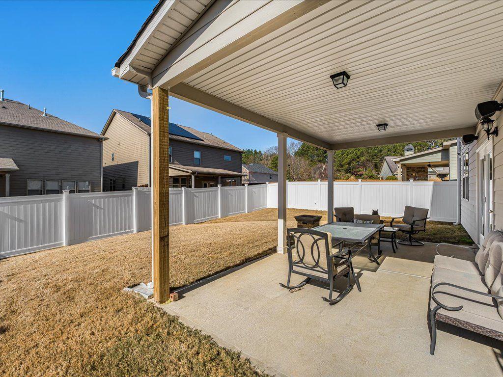 7675 Volion Drive Fairburn, GA 30213 - Photo 9 of 44 a view of a patio with table and chairs with wooden floor