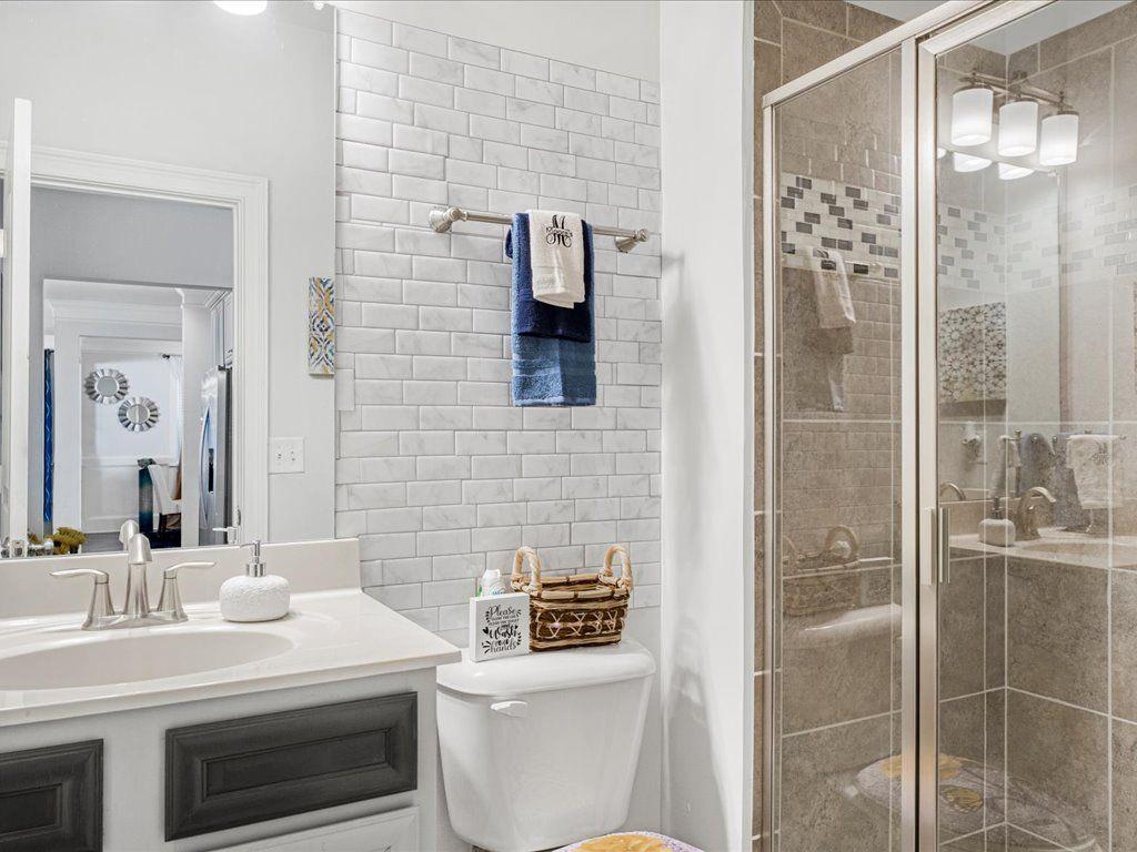 7675 Volion Drive Fairburn, GA 30213 - Photo 10 of 44 a bathroom with a sink a toilet and shower