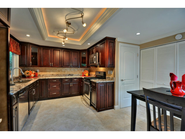 6182 Flowering Plum Road San Jose, CA 95120 - Photo 12 of 23 a kitchen with granite countertop wooden cabinets a sink dishwasher and a stove