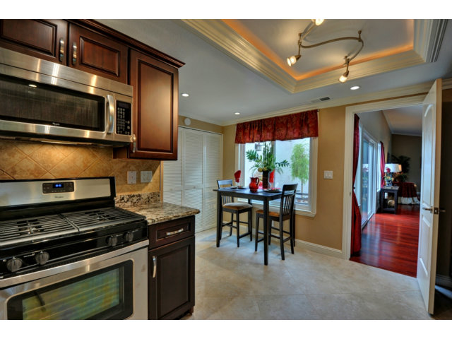 6182 Flowering Plum Road San Jose, CA 95120 - Photo 13 of 23 a kitchen with stainless steel appliances kitchen island granite countertop a stove and cabinets