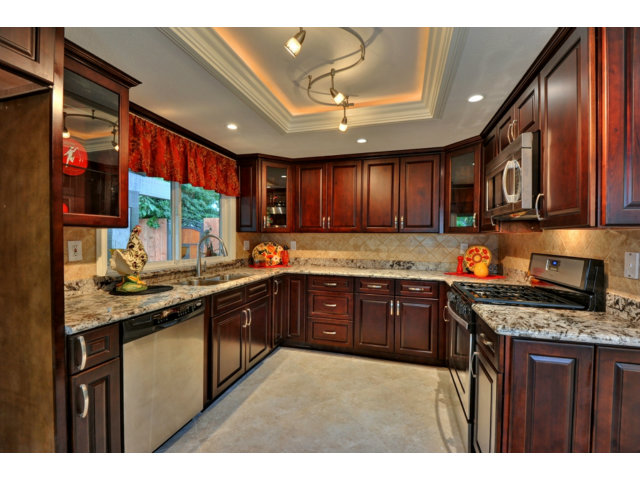 6182 Flowering Plum Road San Jose, CA 95120 - Photo 2 of 23 a kitchen with stainless steel appliances granite countertop wooden cabinets a stove top oven a sink and dishwasher