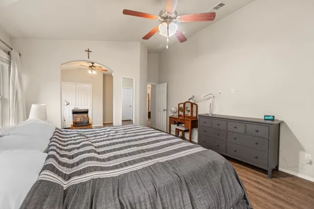 a bedroom with a bed and a chandelier