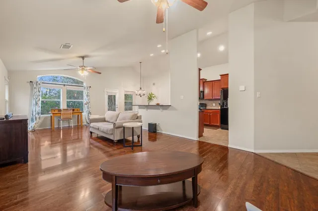 a living room with furniture and kitchen view