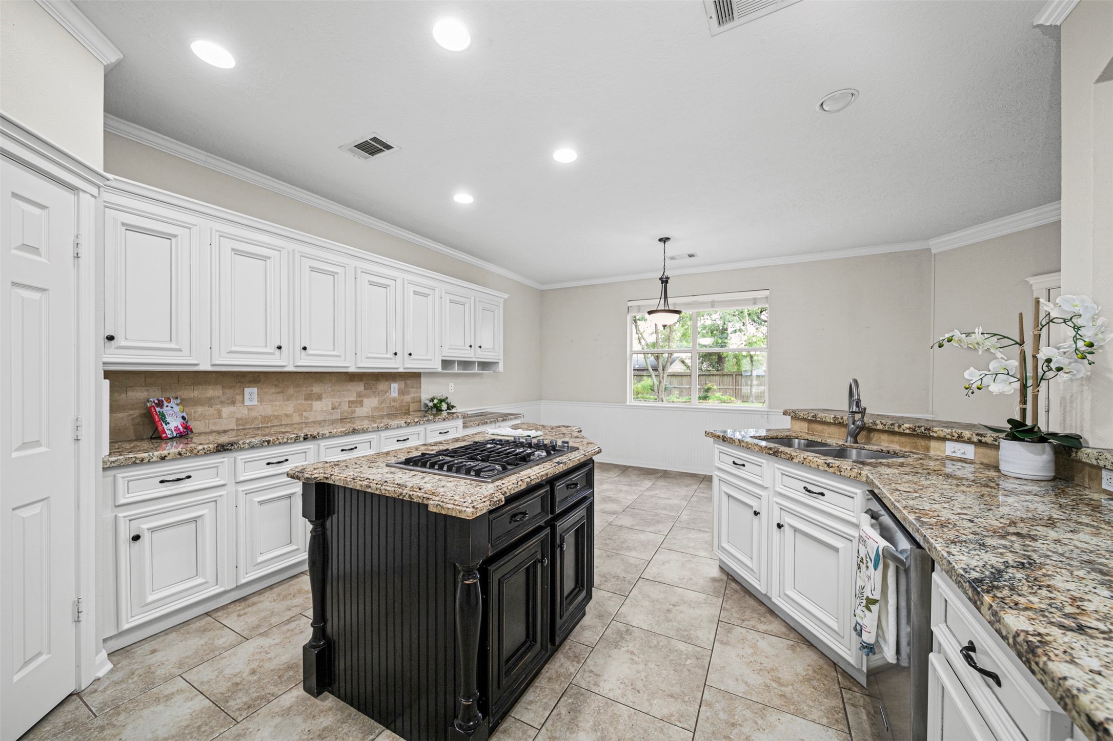 2452 Ripplewood Drive Conroe, TX 77384 - Photo 11 of 31 a kitchen with a stove sink and cabinets