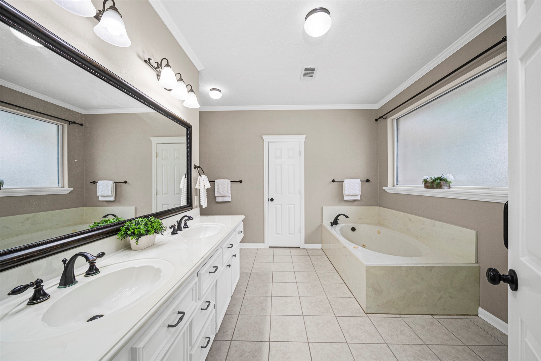 2452 Ripplewood Drive Conroe, TX 77384 - Photo 15 of 31 a spacious bathroom with a tub double sink and mirror