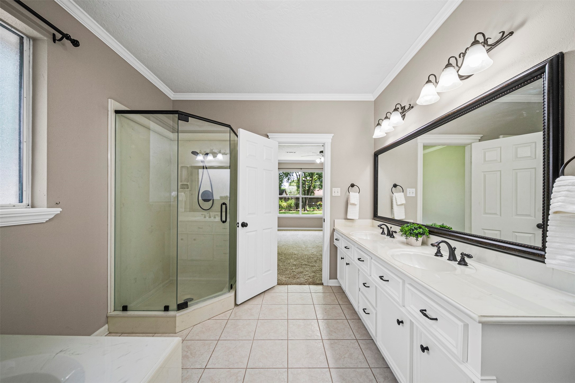 2452 Ripplewood Drive Conroe, TX 77384 - Photo 16 of 31 a spacious bathroom with a double vanity sink mirror and double