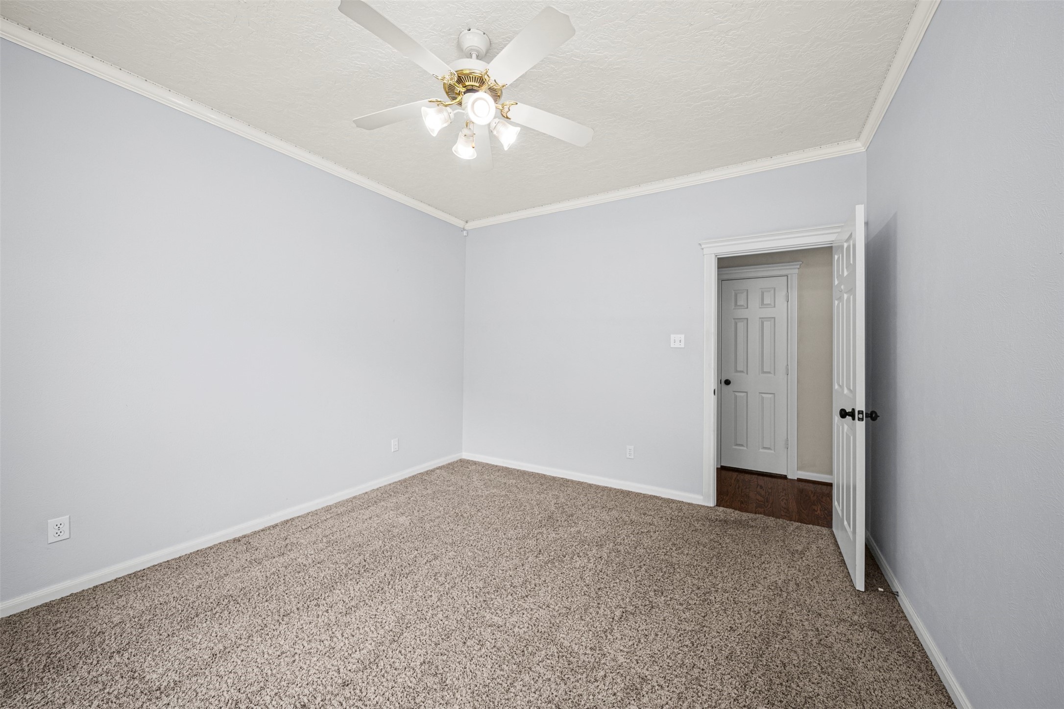 2452 Ripplewood Drive Conroe, TX 77384 - Photo 17 of 31 an empty room with a ceiling fan and a bathroom