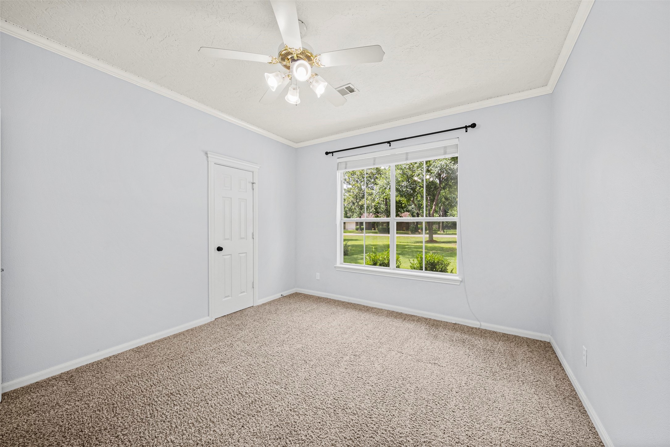 2452 Ripplewood Drive Conroe, TX 77384 - Photo 18 of 31 an empty room with windows and fan