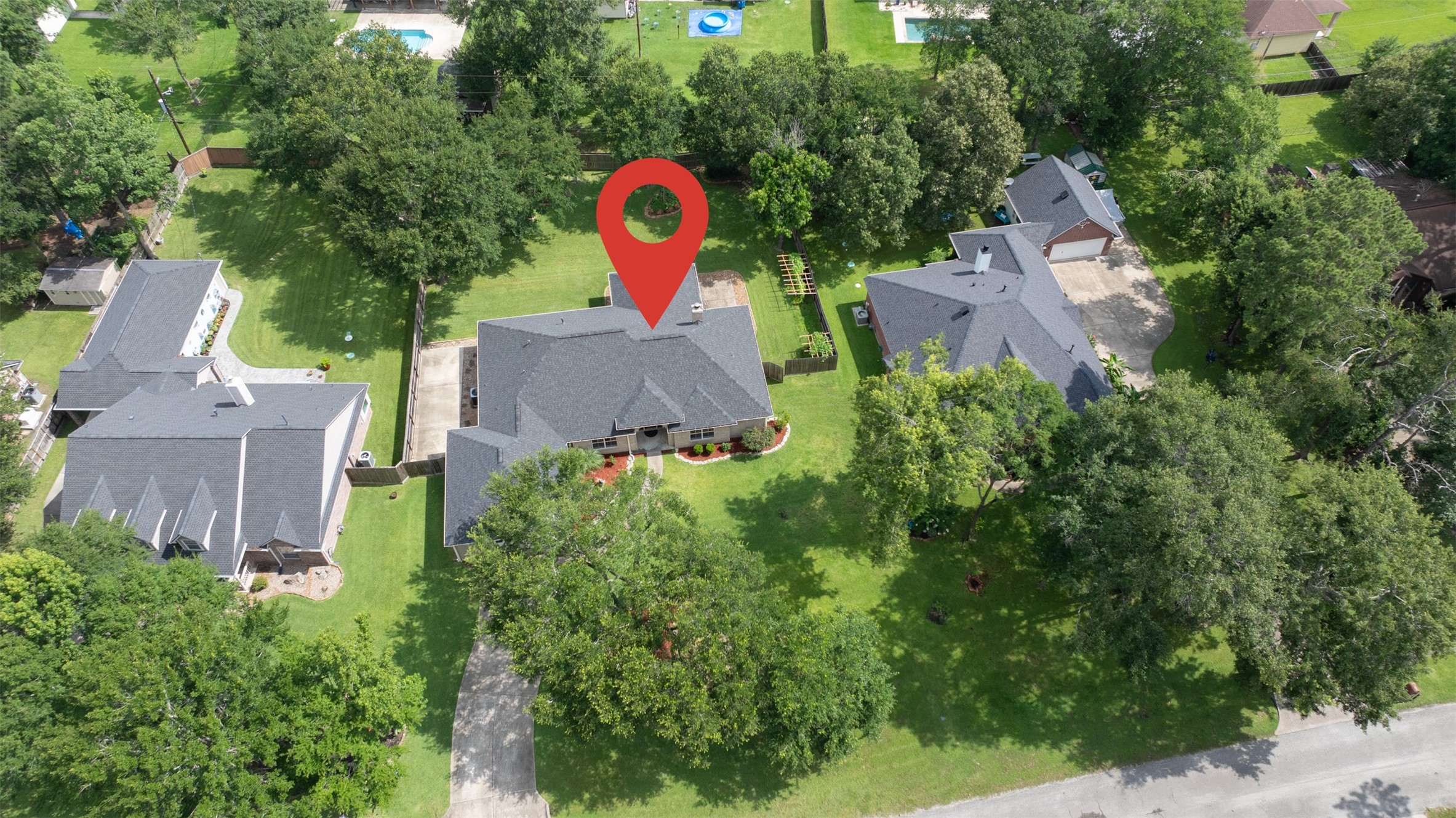 2452 Ripplewood Drive Conroe, TX 77384 - Photo 2 of 31 an aerial view of a house with a yard and trees