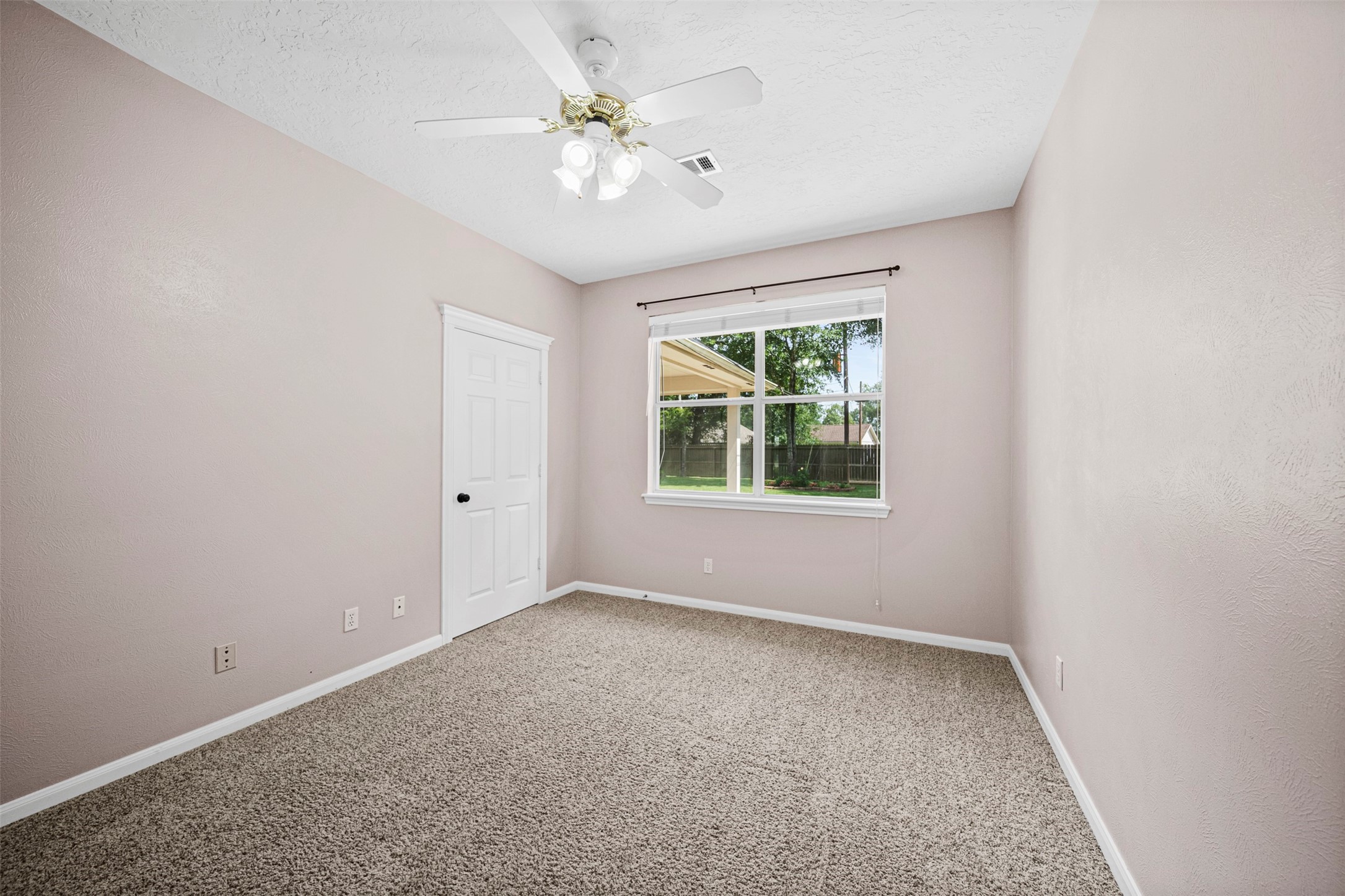2452 Ripplewood Drive Conroe, TX 77384 - Photo 21 of 31 an empty room with windows and ceiling fan