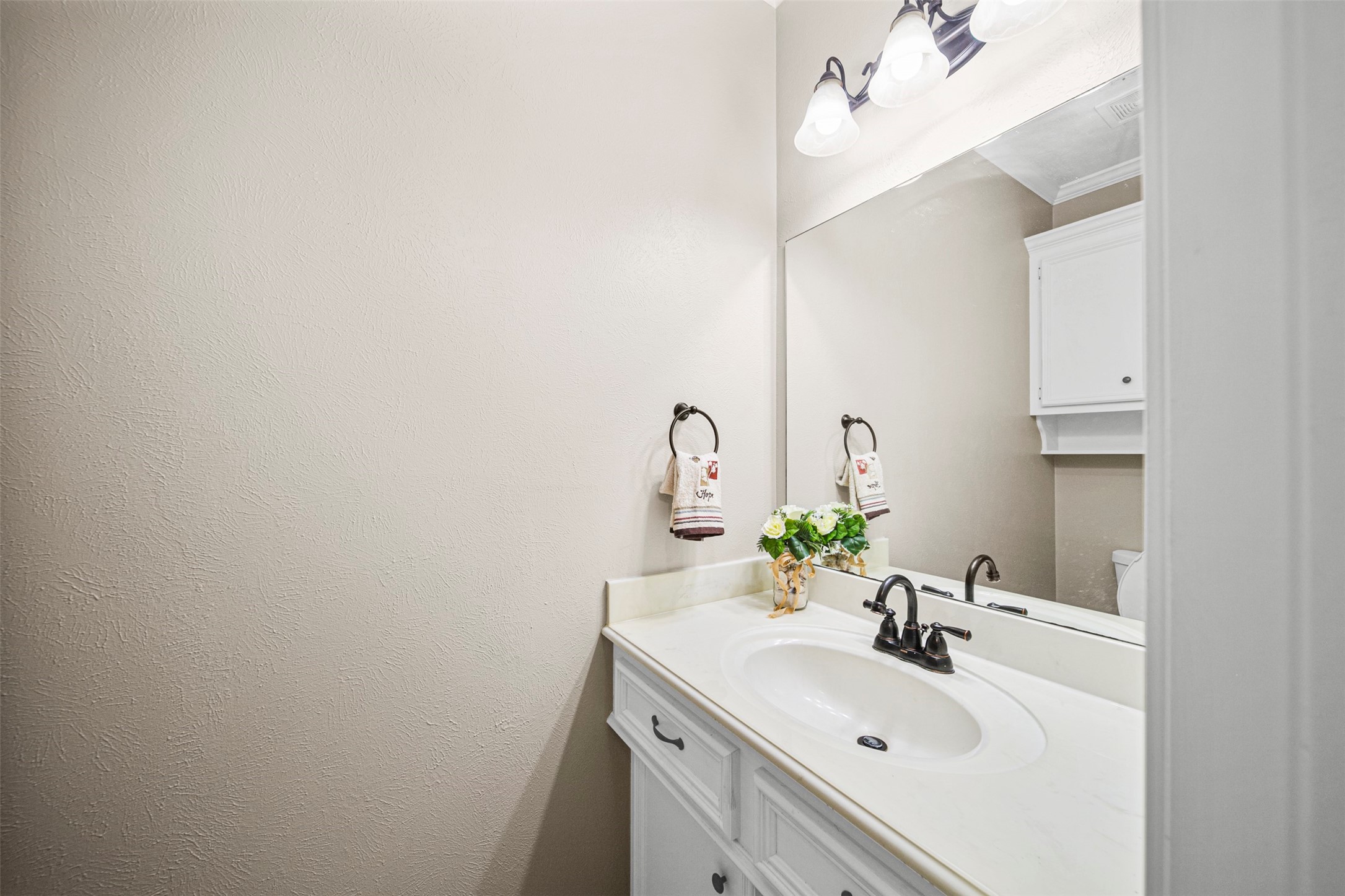 2452 Ripplewood Drive Conroe, TX 77384 - Photo 23 of 31 a bathroom with a sink and a mirror